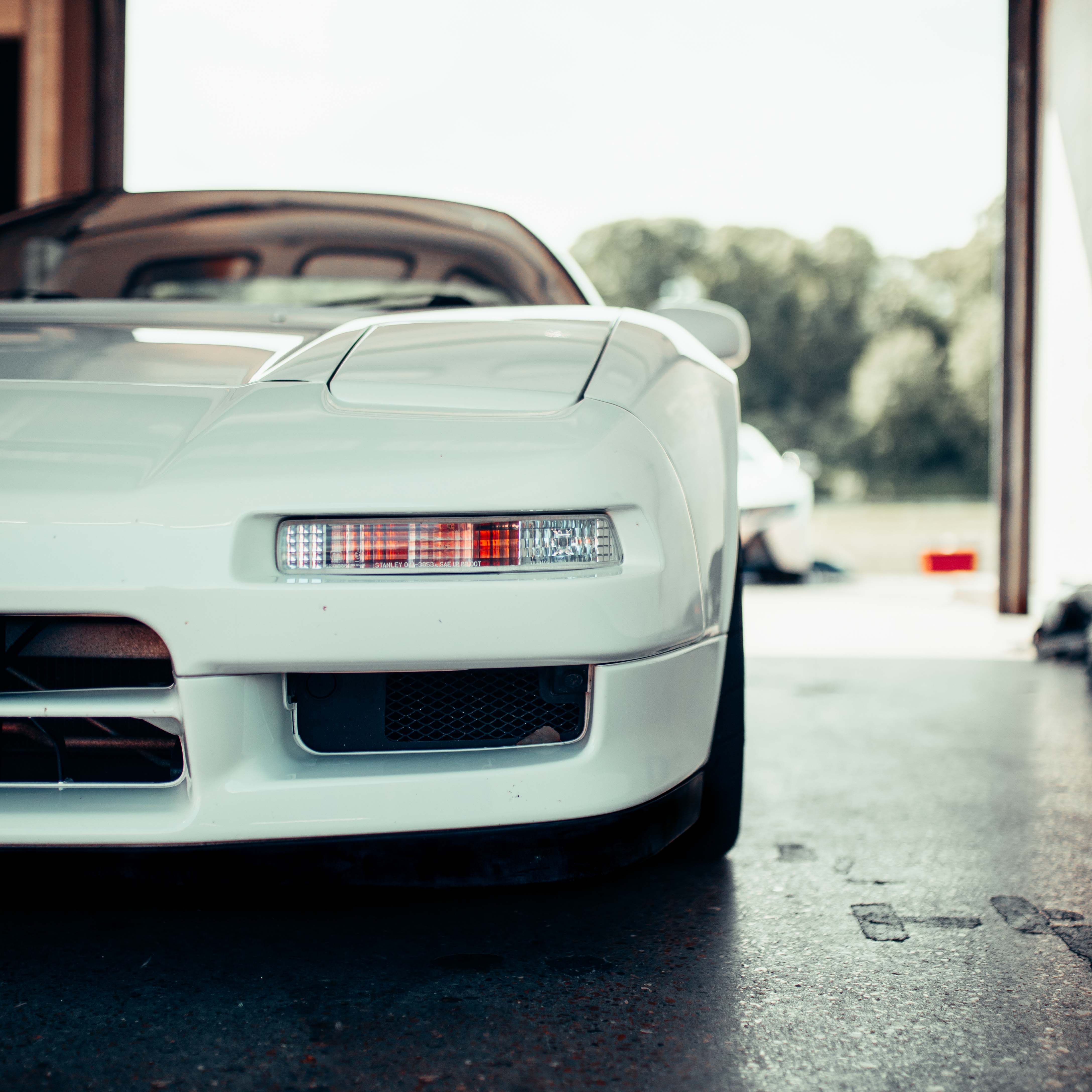 Closeup of white Honda NSX on parking lot – Shooting Brake